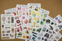 Collection of decorative sticker sheets on a brown surface