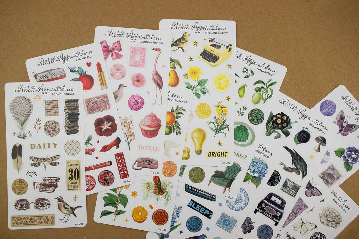 Collection of decorative sticker sheets on a brown surface