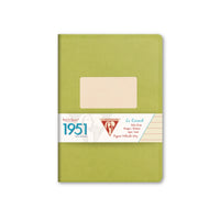Green notebook with a beige label on a white background