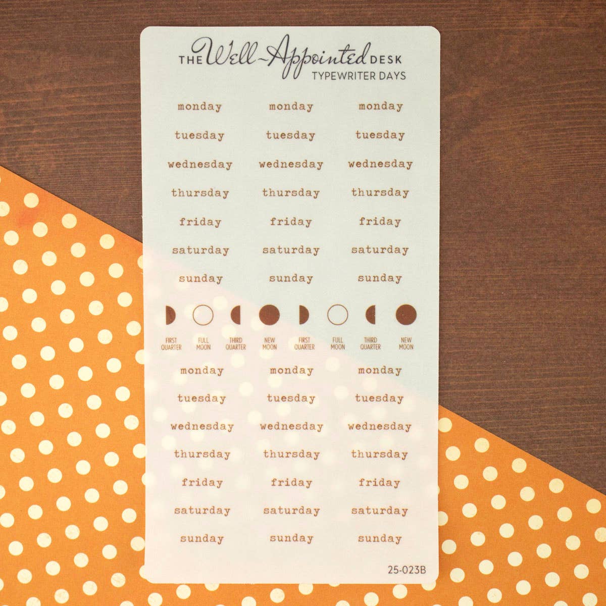 Weekly planner with days of the week and moon phase symbols on a wooden background with polka dot patterns.