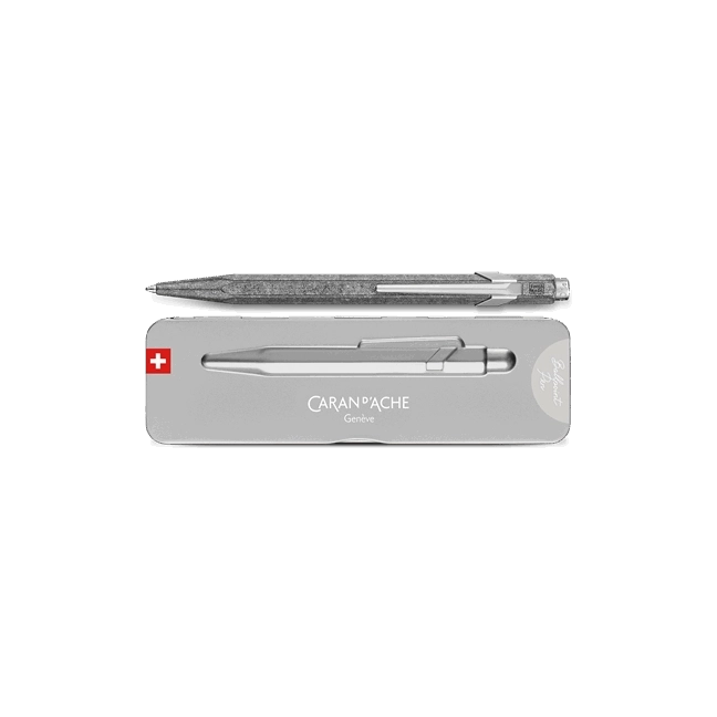 A silver metallic pen with a textured glittery grip, shown above its silver presentation box. The box features the brand name 'CARAN D'ACHE' and a small Swiss flag logo on the left.