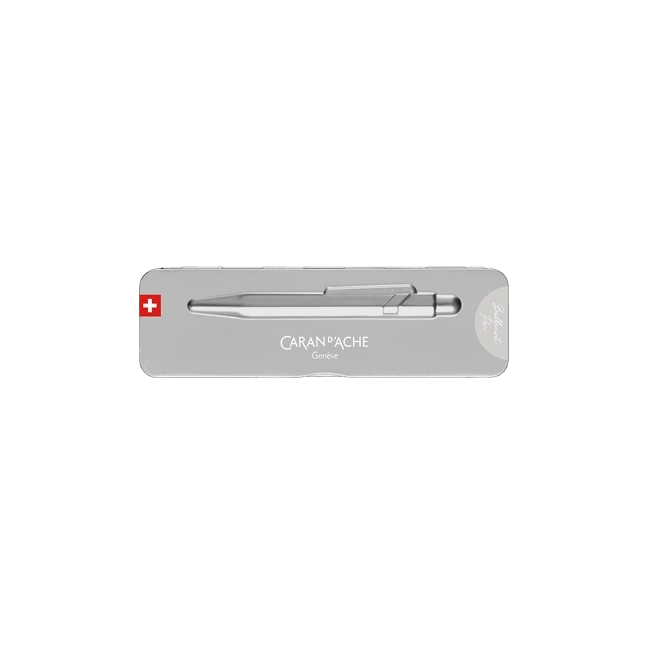 A silver Caran d'Ache pen presented in a slim rectangular silver tin with a Swiss flag emblem, photographed against a solid white background.