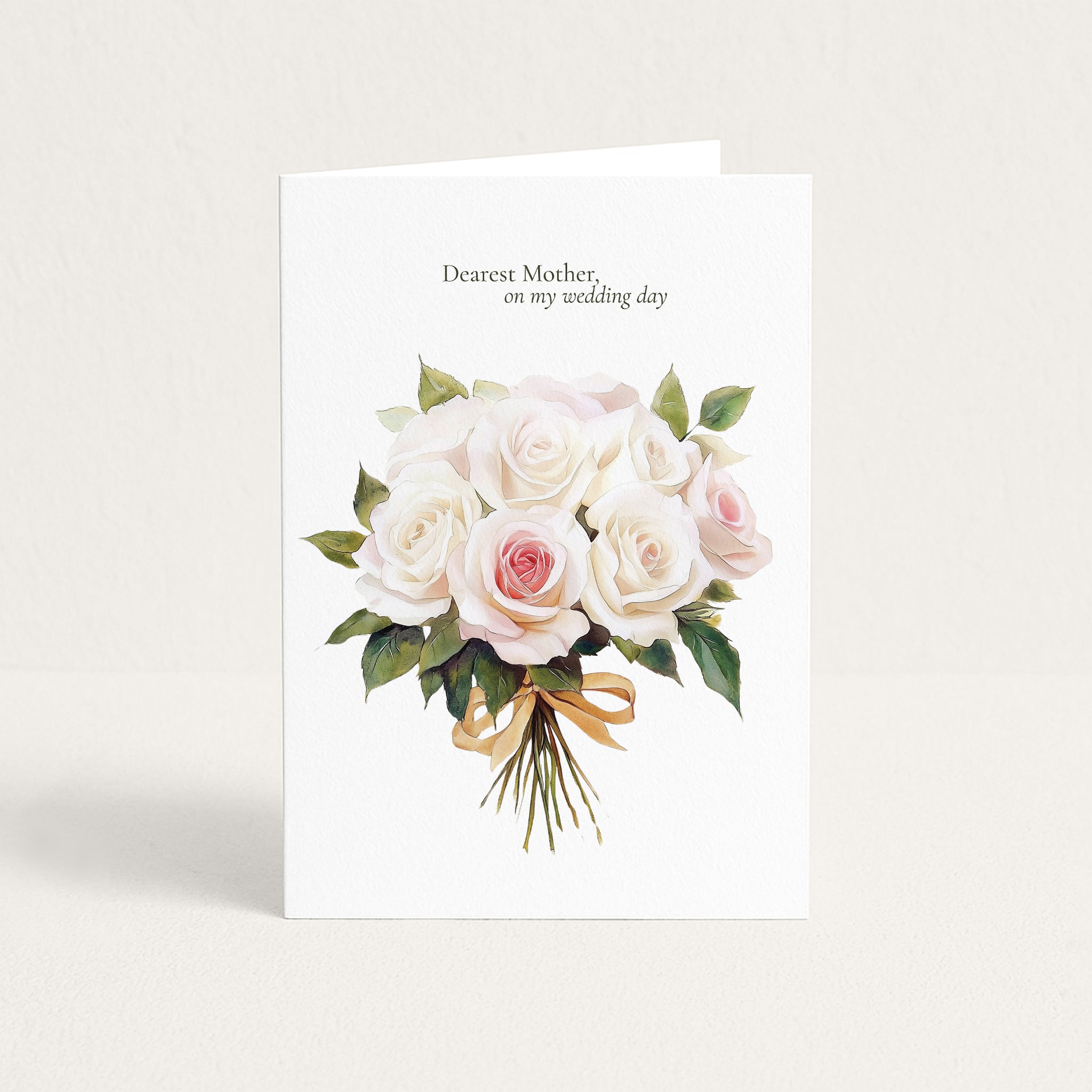 A white greeting card standing upright against a light beige background. The card features a watercolor bouquet of white and pale pink roses with green leaves and a gold ribbon, with the printed text 'Dearest Mother, on my wedding day' at the top.