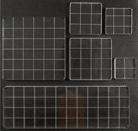 A set of clear acrylic or glass grid trays with white grid lines, shown in multiple sizes on a black textured background.