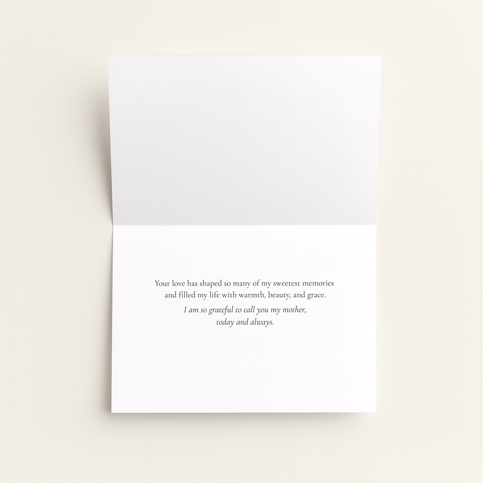 A folded white greeting card with a printed remembrance message in black serif text, photographed against a warm off-white background.
