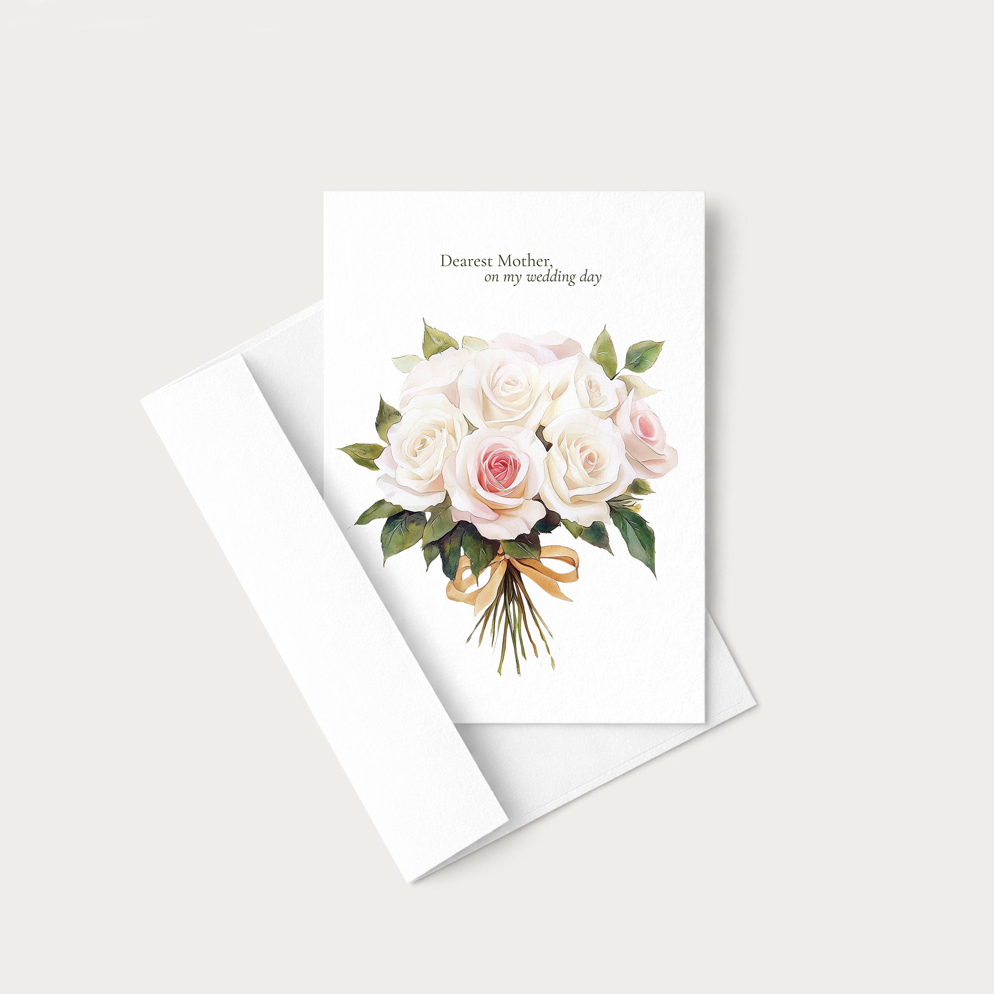 A white greeting card with a watercolor bouquet of pale pink and white roses, green leaves, and a gold ribbon, with the printed message 'Dearest Mother, on my wedding day.' It is shown with a white envelope on a light warm gray background.