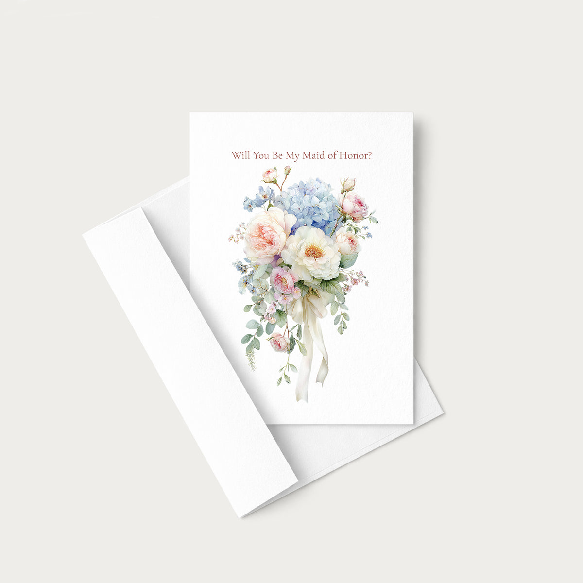 A white greeting card with a watercolor floral bouquet and the text 'Will You Be My Maid of Honor?' in a soft pink font, shown with a matching white envelope on a light gray background.