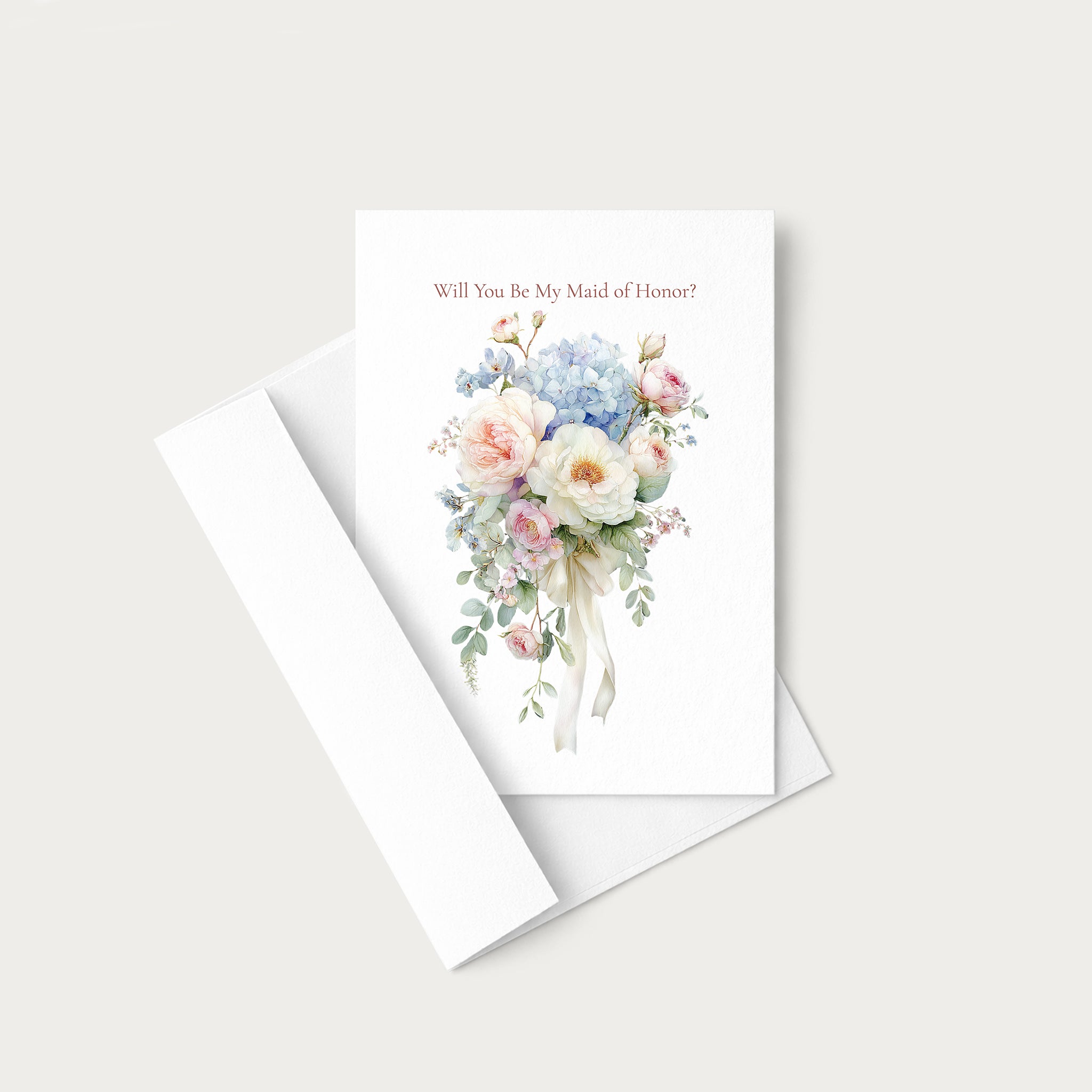 A white greeting card with a watercolor floral bouquet and the text 'Will You Be My Maid of Honor?' in a soft pink font, shown with a matching white envelope on a light gray background.