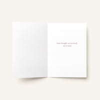 An open white greeting card on a light beige background, with the right page printed with the phrase 'Some thoughts are too lovely not to send.' in a small serif font.