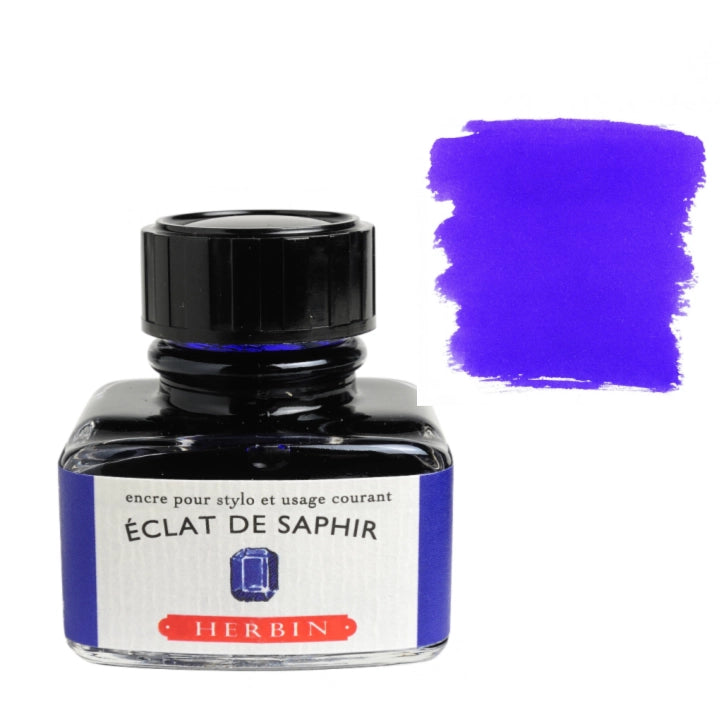 A bottle of Herbin Éclat de Saphir ink with a black cap and a blue label, shown next to a purple ink swatch on a white background.