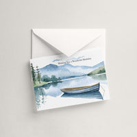 Watercolor lake and rowboat birthday card displayed with a coordinating white pointed-flap envelope.