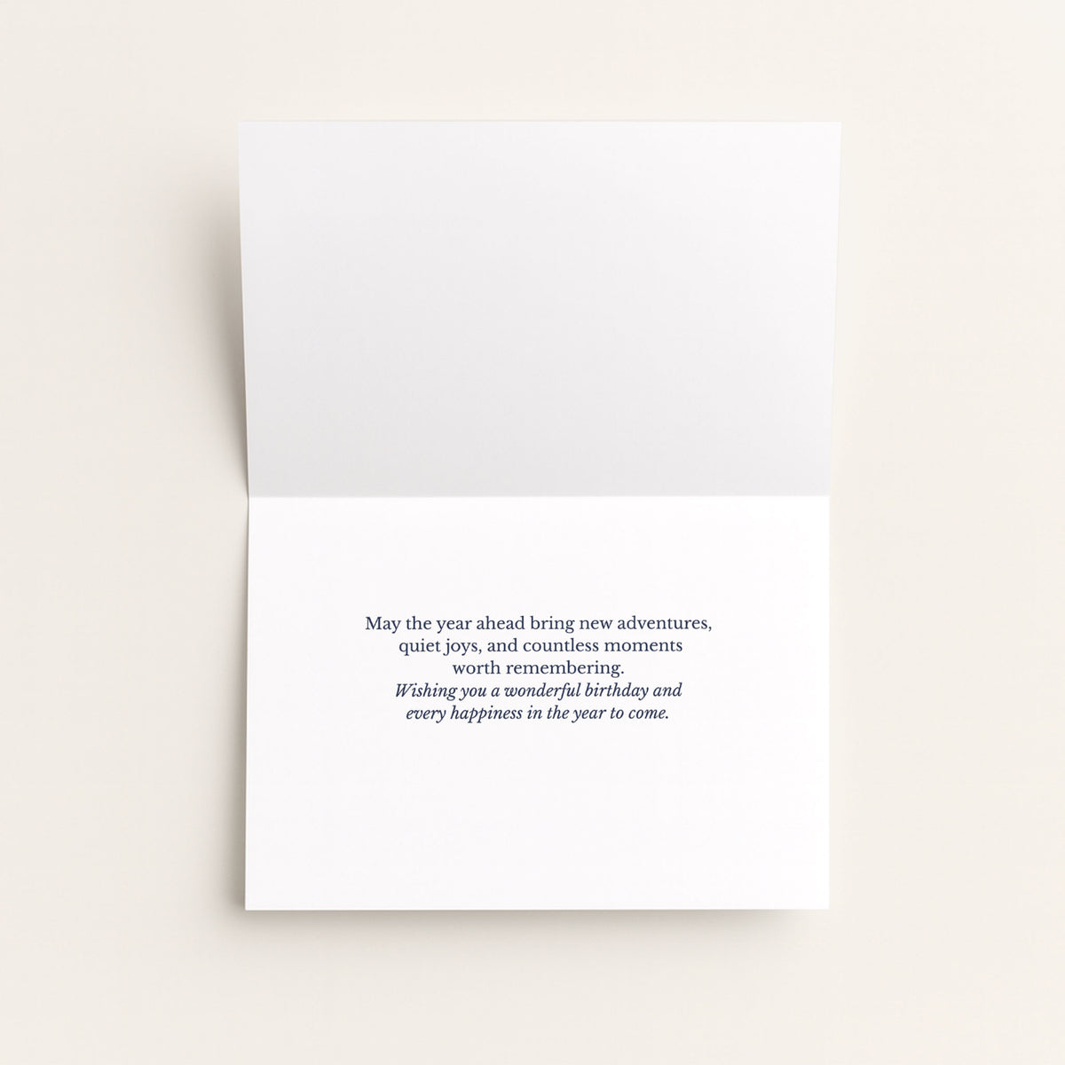 Open birthday card showing the message “May the year ahead bring new adventures, quiet joys, and countless moments worth remembering.”