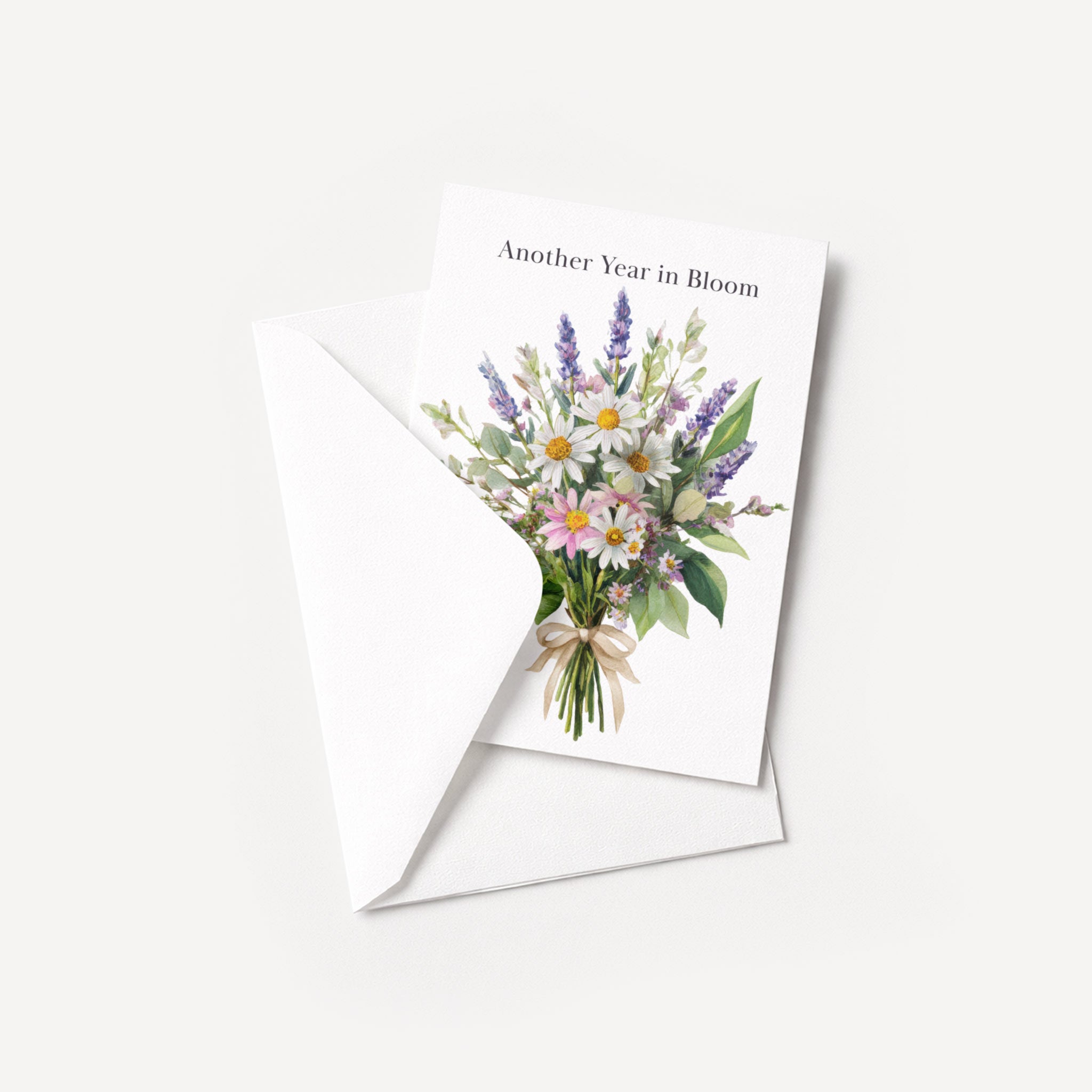 Another Year in Bloom floral birthday card displayed with a coordinating white pointed-flap envelope.