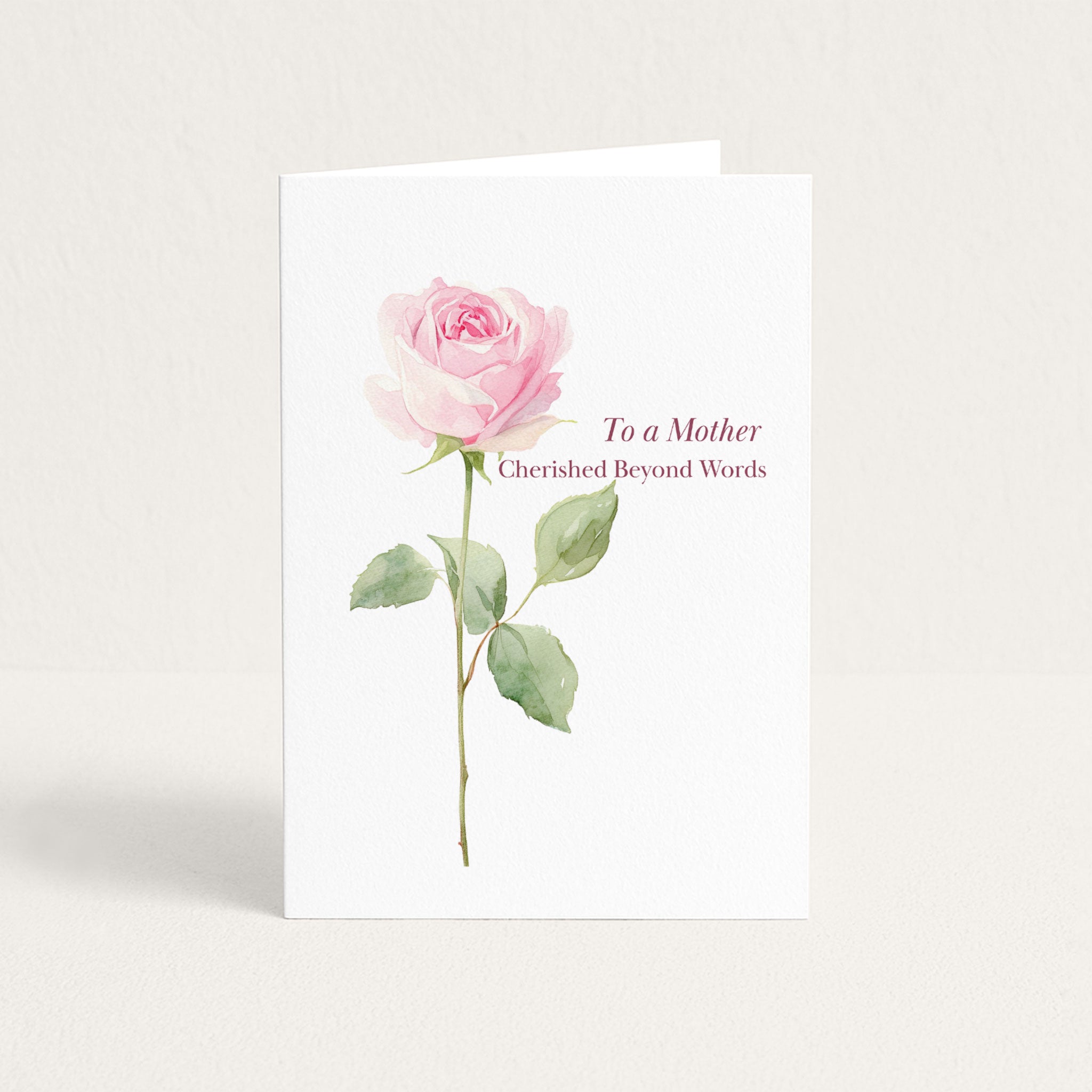 To a Mother Cherished Beyond Words birthday card featuring a single pink watercolor rose on textured white paper.