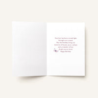 Open To a Mother Cherished Beyond Words card showing the printed birthday message and small butterfly illustration inside.