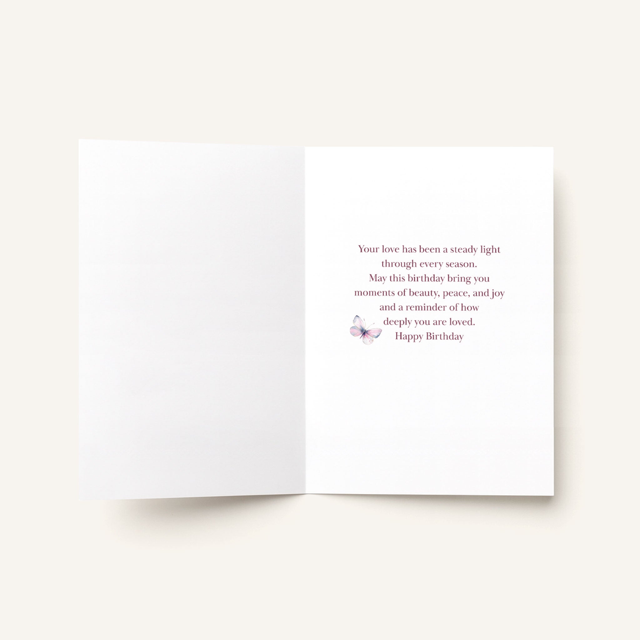 Open To a Mother Cherished Beyond Words card showing the printed birthday message and small butterfly illustration inside.