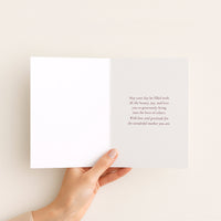 Open birthday card for Mom held by hand, showing a message of beauty, joy, love, and gratitude.