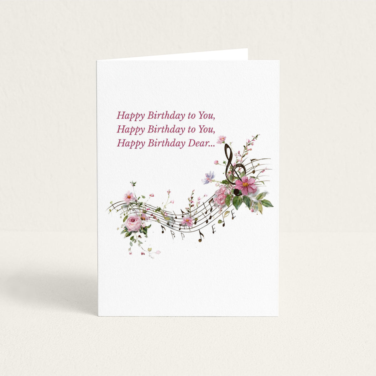 Happy Birthday Dear card featuring floral musical notes, pink blossoms, and the opening lines of the birthday song.