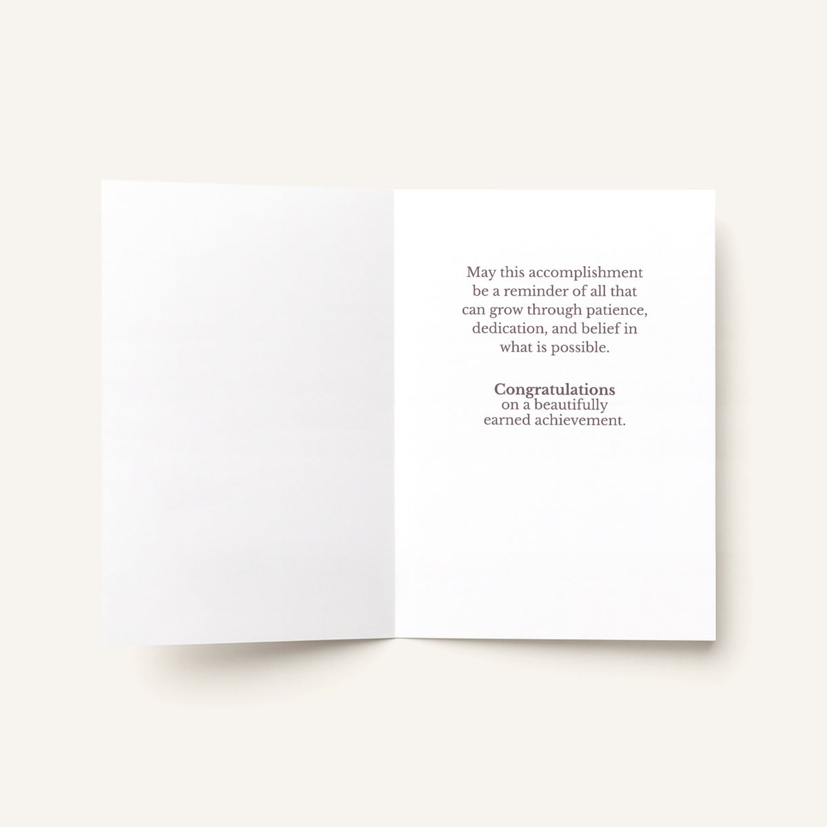 Open congratulations card showing the message “Congratulations on a beautifully earned achievement.”