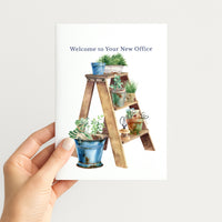 Hand holding a retirement card illustrated with potted plants, gardening tools, and a rustic wooden ladder.