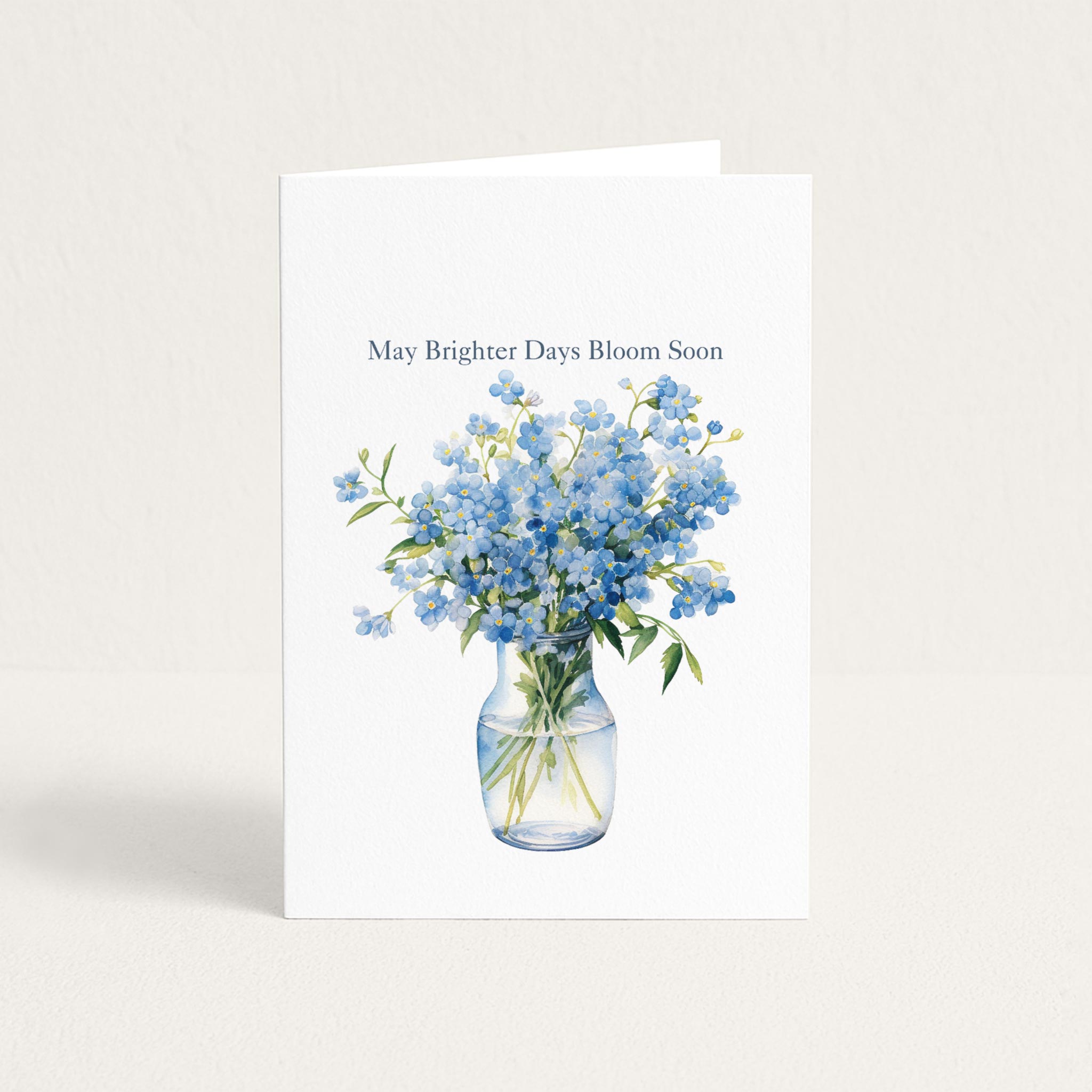 Get-well card featuring a watercolor bouquet of blue forget-me-nots in a glass vase with the message “May Brighter Days Bloom Soon.”