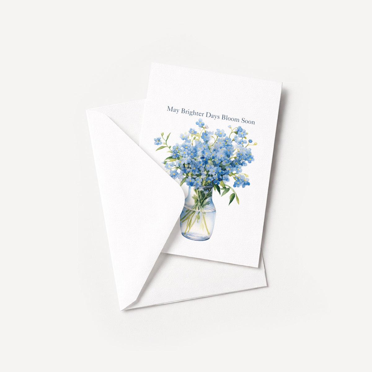 Blue floral get-well card displayed with a coordinating white pointed-flap envelope.