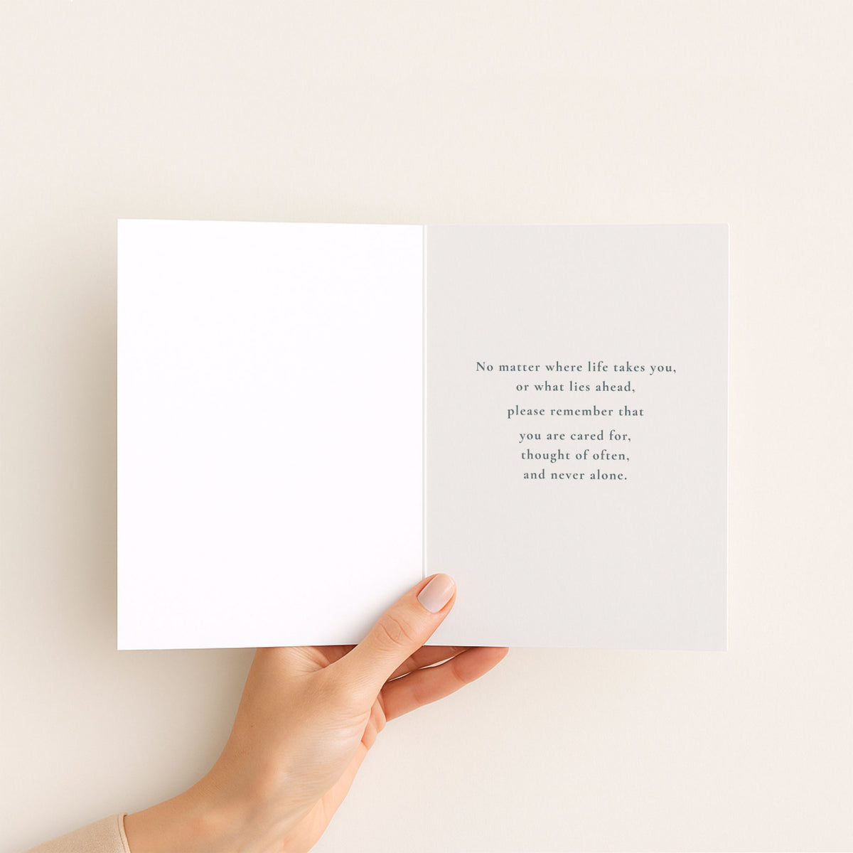 Open encouragement card held in hand, showing a reassuring message that the recipient is cared for, thought of often, and never alone.