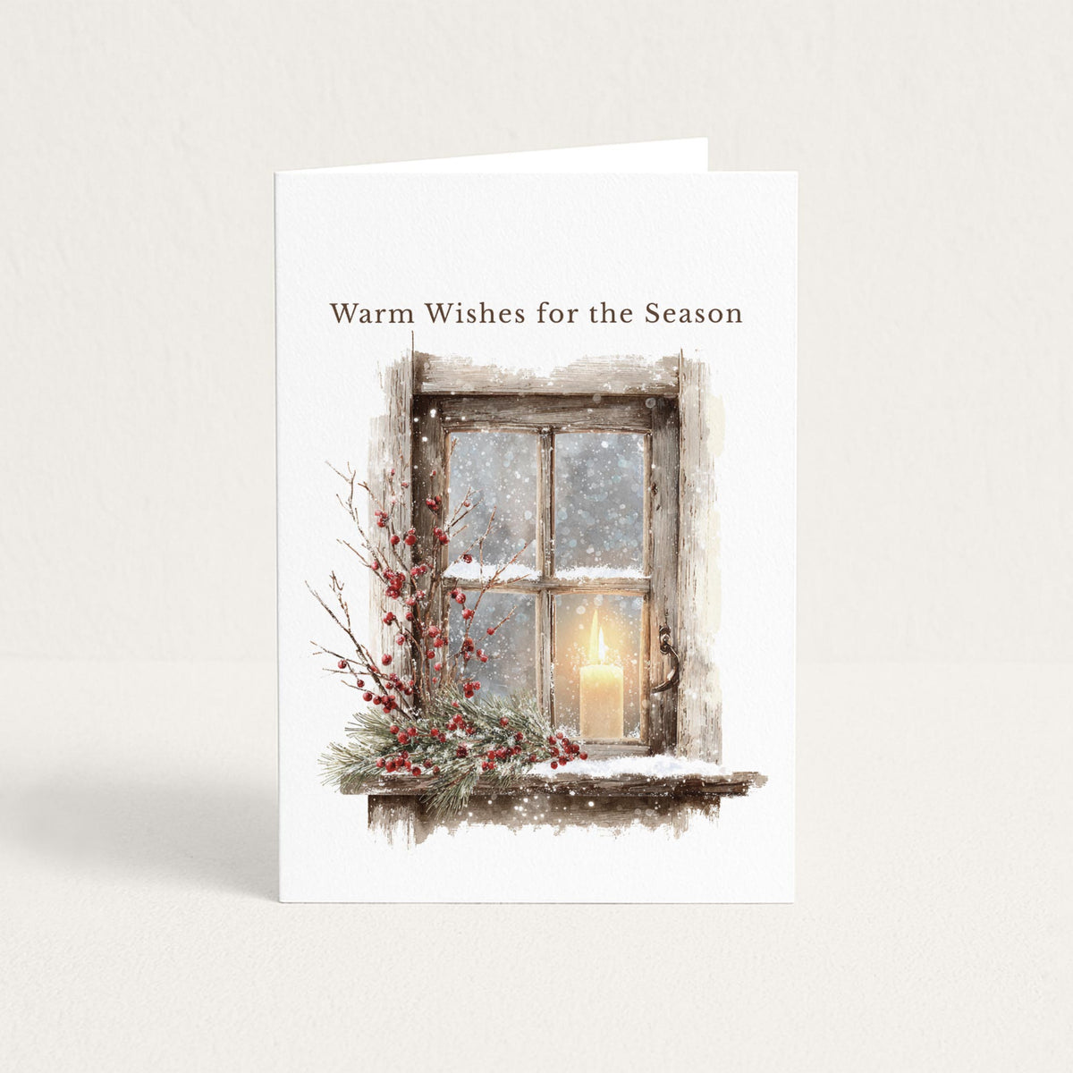 Seasonal greeting card featuring a snowy rustic window, glowing candle, evergreen branches, and red berries beneath the words “Warm Wishes for the Season.”