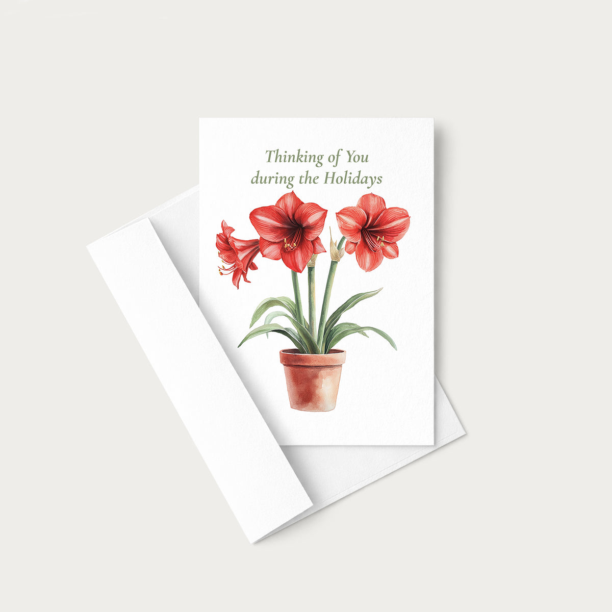 Amaryllis holiday greeting card displayed with a coordinating white pointed-flap envelope.