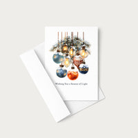 Wishing You a Season of Light holiday card displayed with a coordinating white pointed-flap envelope.