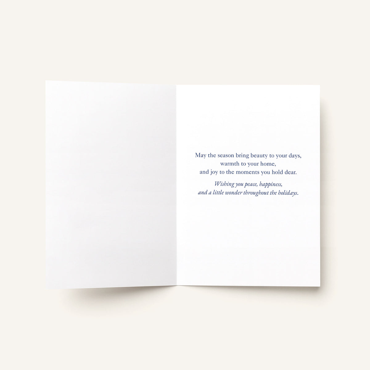 Open holiday greeting card showing a printed message about beauty, warmth, joy, peace, happiness, and seasonal wonder.