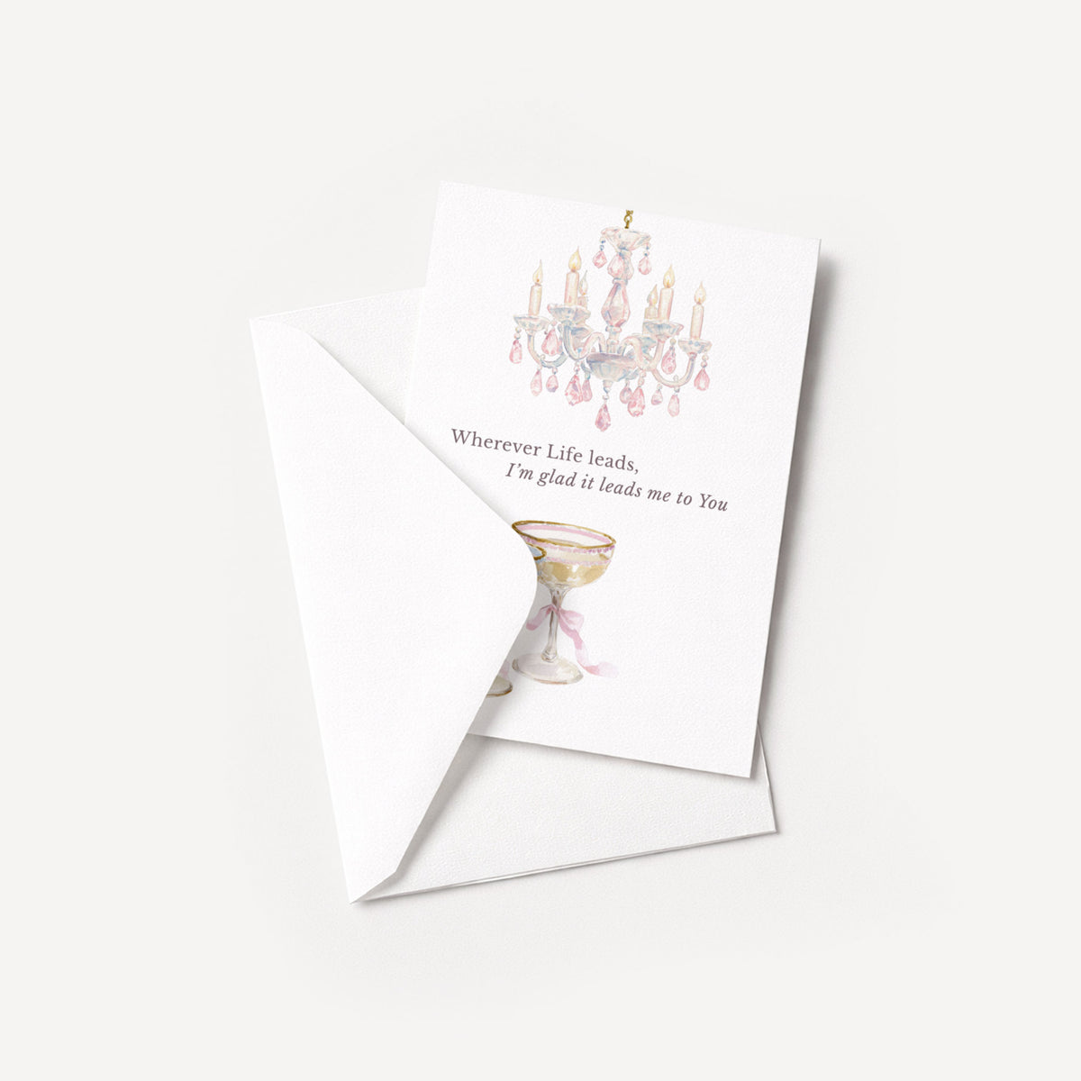Romantic chandelier and champagne coupe card displayed with a coordinating white pointed-flap envelope.