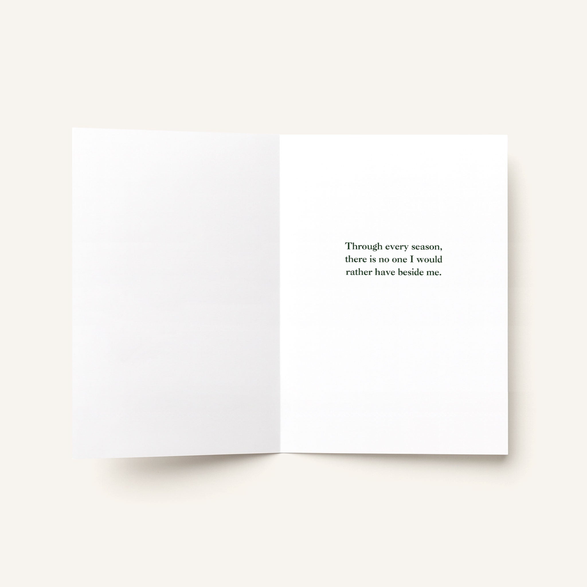Open love greeting card showing a printed message about sharing every season with someone special.