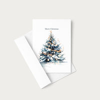 Watercolor Christmas tree greeting card displayed with a coordinating white envelope on a neutral background.