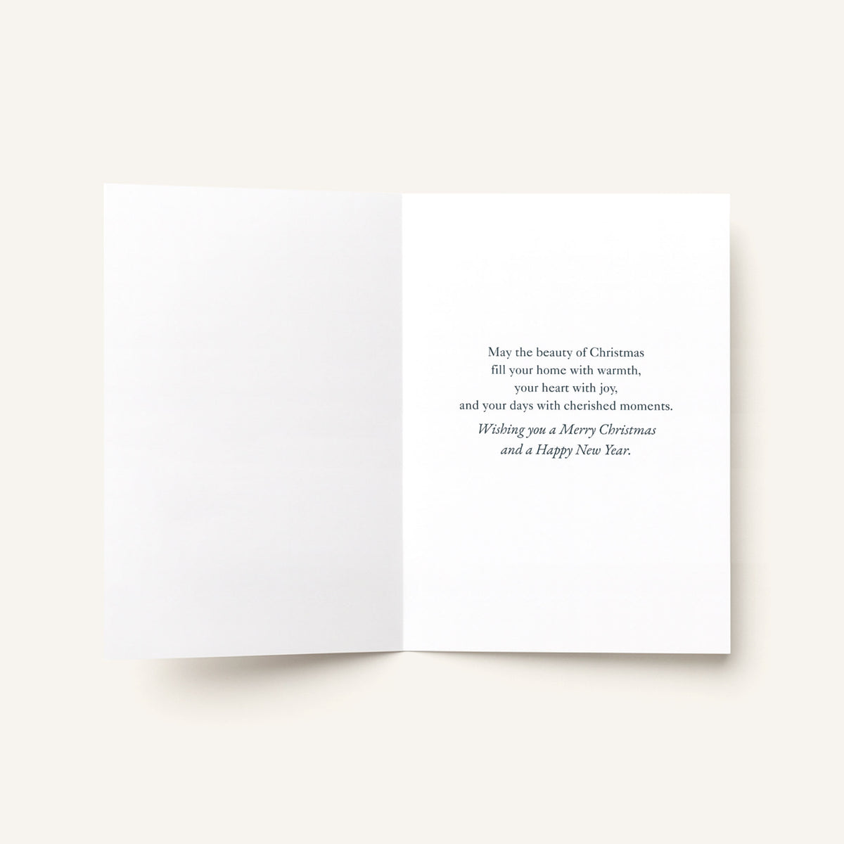 Open Christmas greeting card showing a printed message wishing a Merry Christmas and Happy New Year.