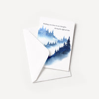 Blue forest sympathy card displayed with a coordinating white pointed-flap envelope.