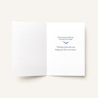Open sympathy card showing a blue bird and the message “Some seasons of life are impossibly heavy. Thinking of you often and holding you close in our hearts.”