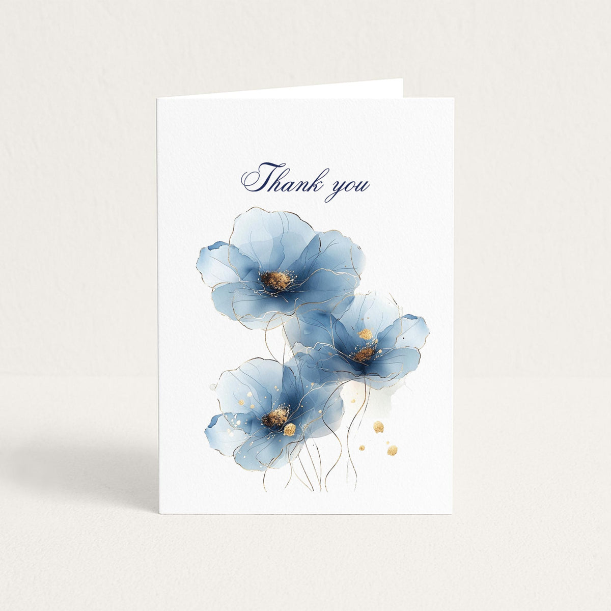 Thank-you greeting card featuring three soft blue watercolor flowers with delicate gold accents on white textured paper.