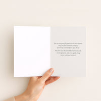 Open renewal and encouragement card held by hand, showing a message of renewed strength, quiet hope, and brighter days.