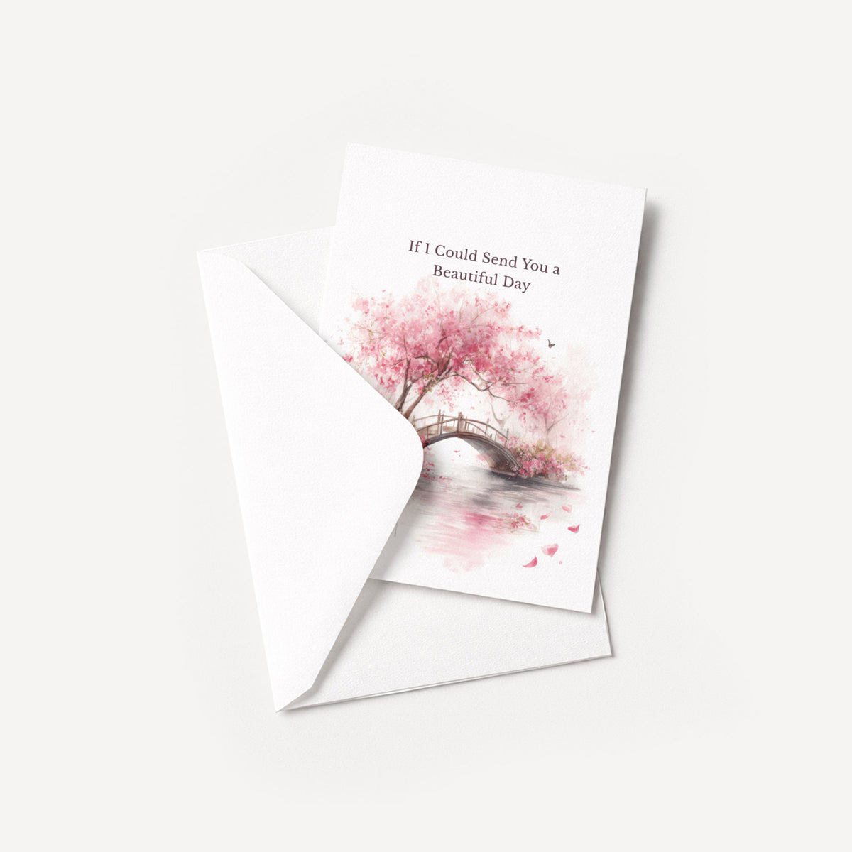 Pink cherry blossom thinking-of-you card displayed with a coordinating white pointed-flap envelope.