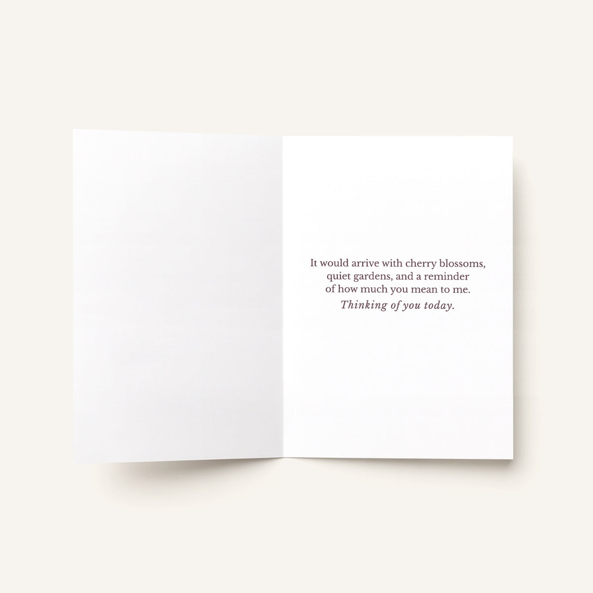 Open thinking-of-you card showing the printed message about cherry blossoms, quiet gardens, and how much the recipient means.