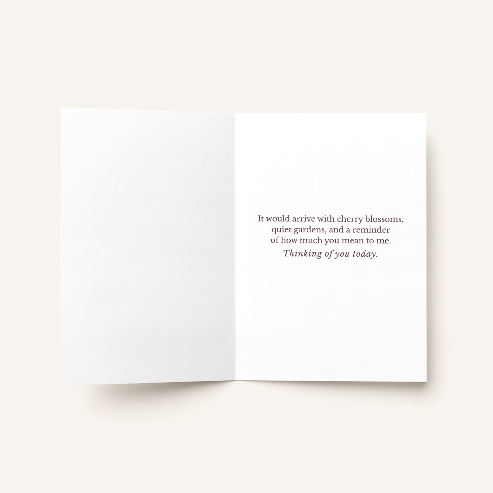 Open thinking-of-you card showing the printed message about cherry blossoms, quiet gardens, and how much the recipient means.