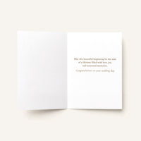 Open A Beautiful Beginning wedding card showing the printed congratulatory message inside.