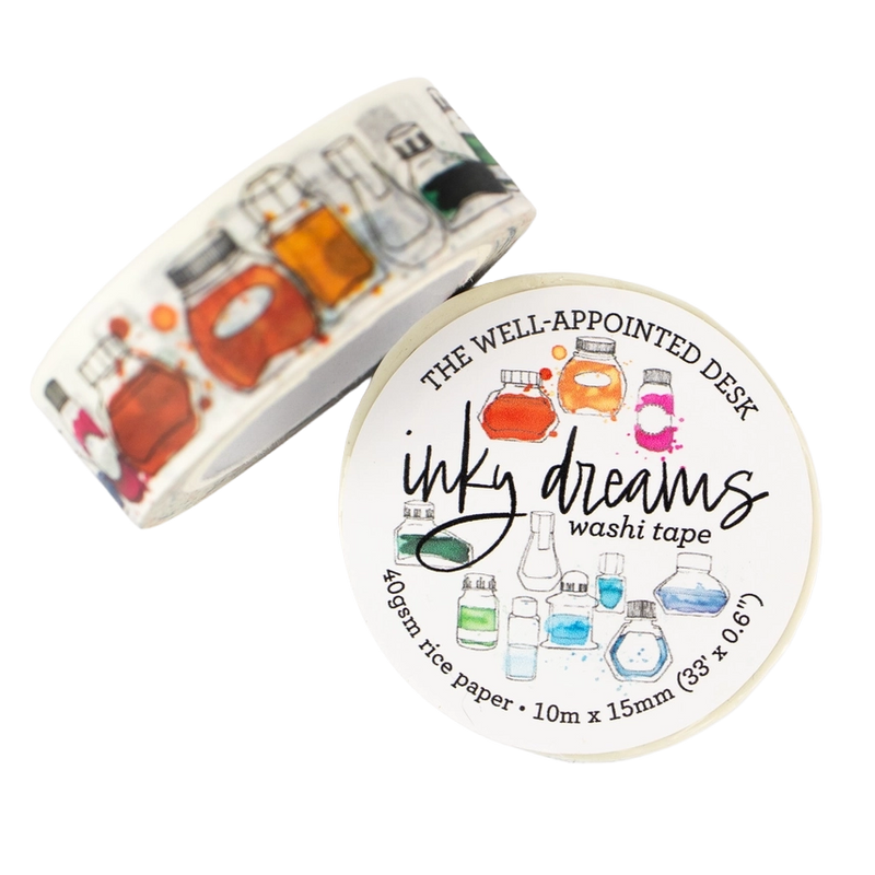A roll of washi tape and its circular label, both featuring a white background with colorful illustrations of glass laboratory bottles and beakers. The label reads 'THE WELL-APPOINTED DESK', 'inky dreams', and 'washi tape'.
