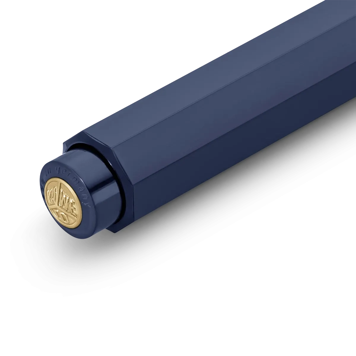 Close-up of a dark navy blue cylindrical product, likely a pen or tool, showing a gold circular emblem on the cap against a clean white background.