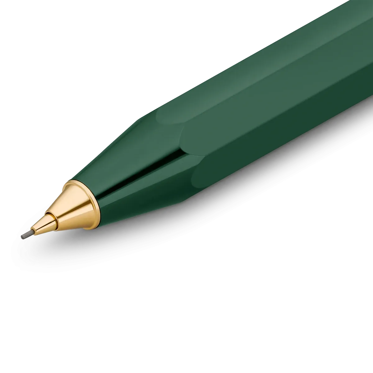 A close-up of a faceted dark green pen tip with a polished gold metal point and a silver writing nib, shown on a clean white background.