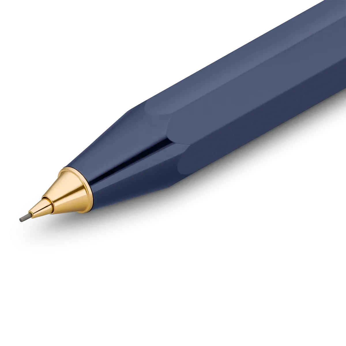 A close-up of a faceted navy blue pen tip with a polished gold metal cone and a fine silver writing point, shown on a clean white background.