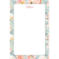 Front view of the Blush Garden memo pad with blush and coral flowers, a soft sage border, rounded writing panel, and subtle dot pattern.