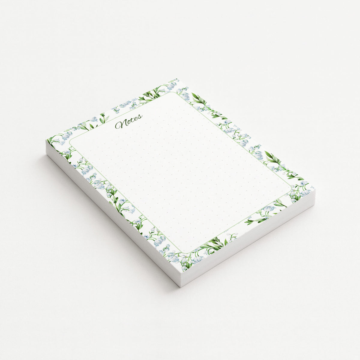 Lily of the Valley memo pad shown at an angle with pale blue bell-shaped flowers, green leaves, a script Notes heading, and subtly dotted writing area.