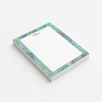 Gilded Mosaic memo pad shown at an angle with a jewel-toned turquoise and blue border, gold-colored geometric detailing, and subtly dotted writing area.
